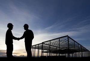 Construction site building handshake