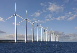 Enormous windmills standing in the sea