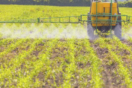Agribusiness Spreading herbicide